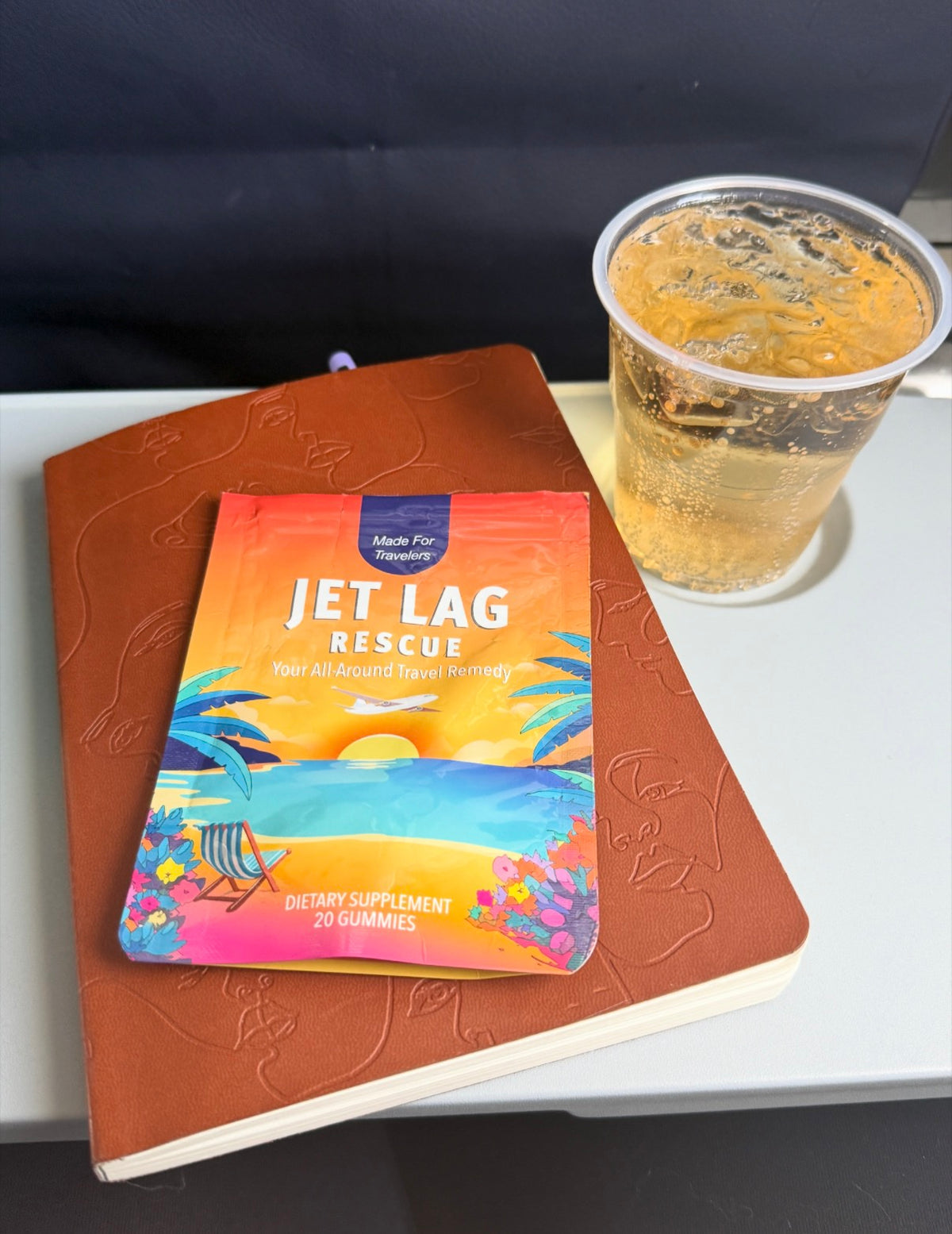 Jet Lag Rescue pouch on an airplane tray table